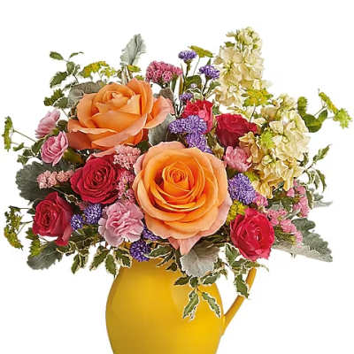 Mixed bouquet of roses and small purple flowers in a yellow pitcher vase