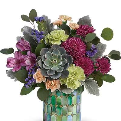 Mixed bouquet in a mosaic glass vase with a central succulent
