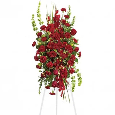 Tall red floral standing spray on a white easel