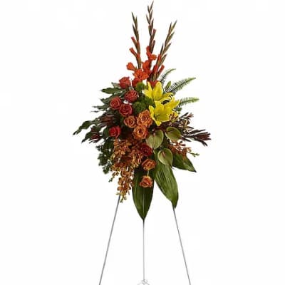 Tall floral spray on a metal easel with red, orange, and yellow flowers
