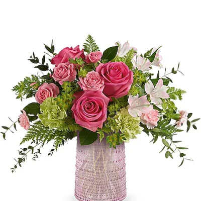 Pink roses and white lilies arranged in a pink textured vase