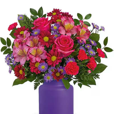 Pink roses and mixed daisies in a purple vase