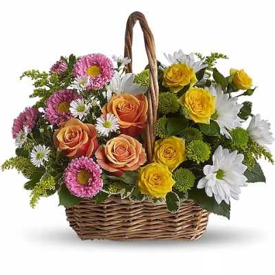Basket of mixed roses and daisies in pink, yellow, orange, and white