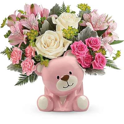 Pink teddy bear container holding pink and white flowers