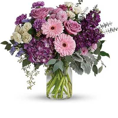 Pink and purple mixed bouquet in a clear glass vase