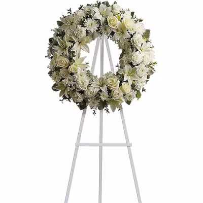 White floral wreath on a standing easel