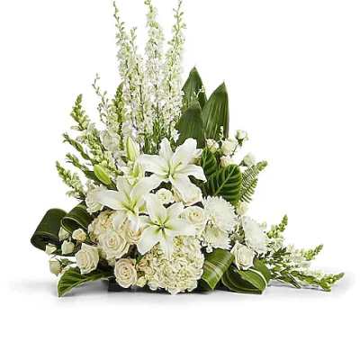 White floral arrangement with lilies, roses, and tall white spikes