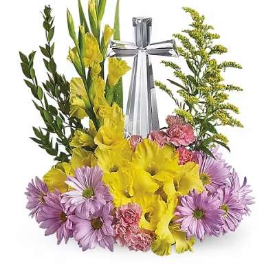 Yellow gladiolus and purple daisies arranged around a silver cross
