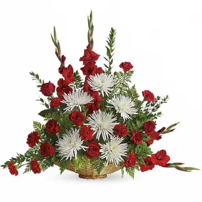 Red and white floral arrangement in a wicker basket