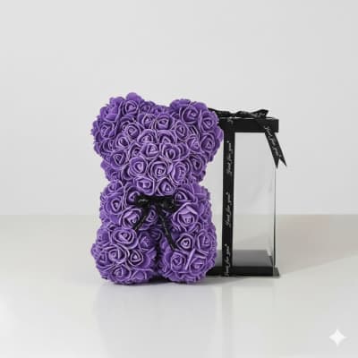 Purple rose teddy bear with a black ribbon on a clear stand