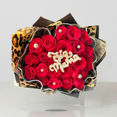 Bouquet of red roses with pearl accents and leopard-print wrapping
