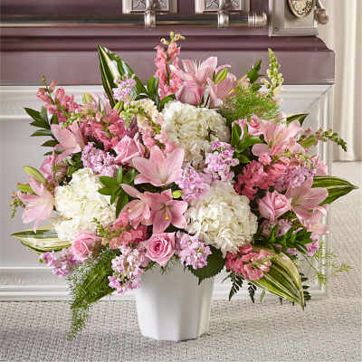 Pink and white floral arrangement in a white vase