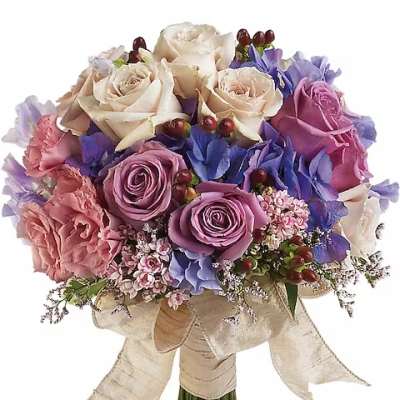Bouquet of cream, pink, and purple roses with a satin ribbon wrap