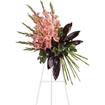 Pink floral standing spray on a white easel