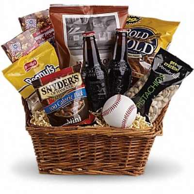 Basket of snacks with two beer bottles and a baseball