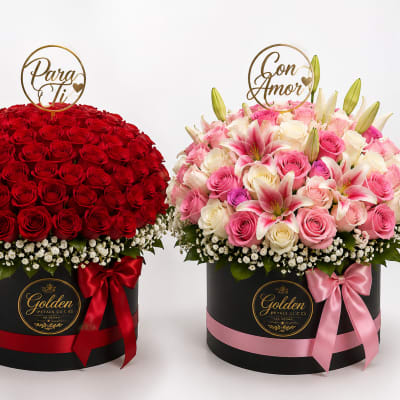 Two round flower boxes with red roses and pink mixed blooms