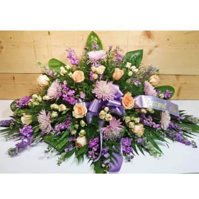 Large purple and peach floral spray with a lavender ribbon