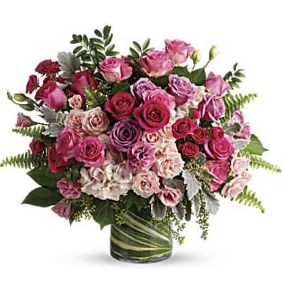 Pink and purple rose bouquet in a glass vase