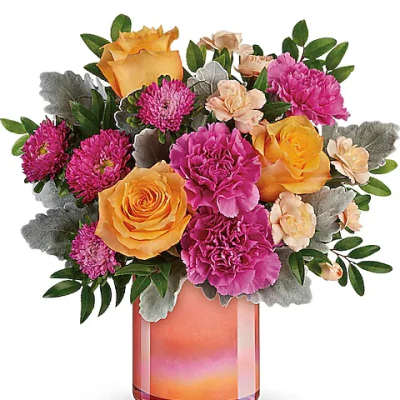 Bouquet of orange roses and pink carnations in a glass vase