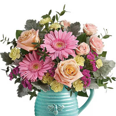 Pink and peach roses with pink daisies in a turquoise mug vase