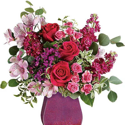 Bouquet of red and pink roses in a glittery purple vase