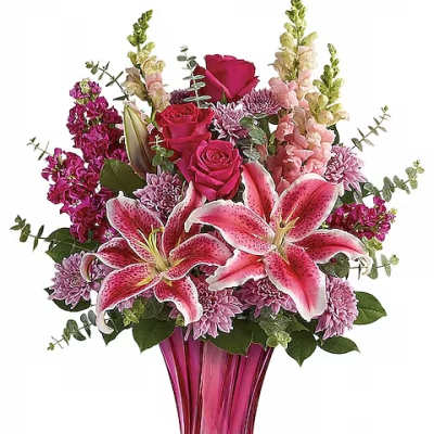 Pink lilies and roses in a tall magenta vase