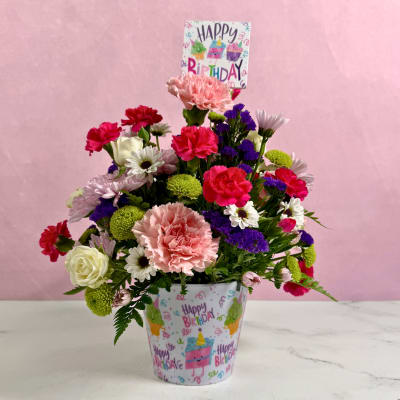 Mixed bouquet in a birthday-themed pot with a Happy Birthday sign