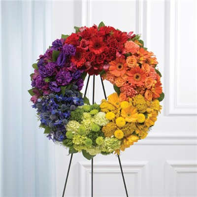 Rainbow floral wreath on a black stand