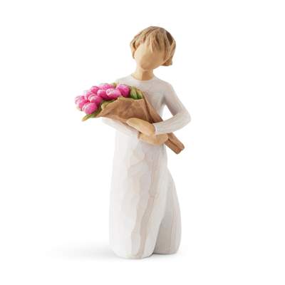 Figurine of a woman holding a bouquet of pink tulips