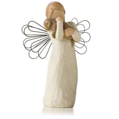 Wood-look angel figurine with wire wings cradling a small dog in its arms