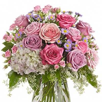 Pink and lavender rose bouquet in a clear glass vase