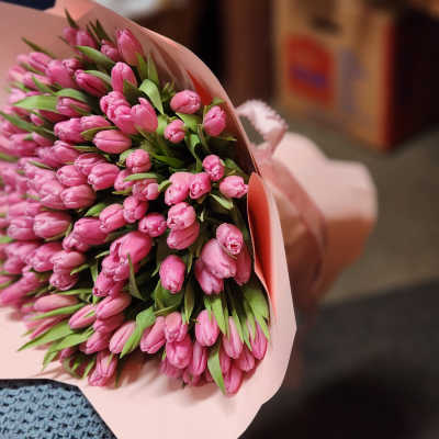 Bouquet of pink tulips wrapped in pale pink paper