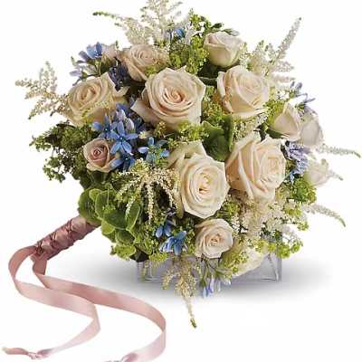Bouquet of cream roses with blue accents and a pink ribbon handle