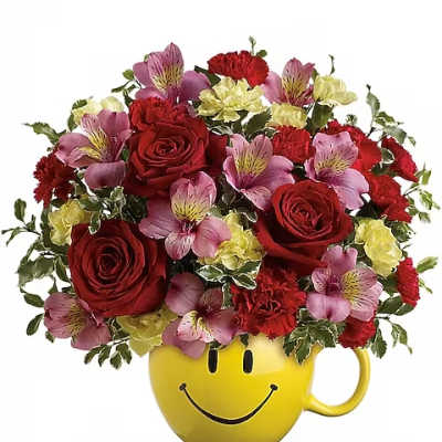 Bouquet of red roses, pink alstroemeria, and carnations in a yellow smiley-face mug