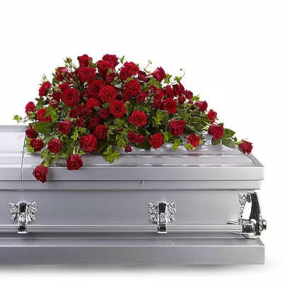 Red rose casket spray on a silver casket