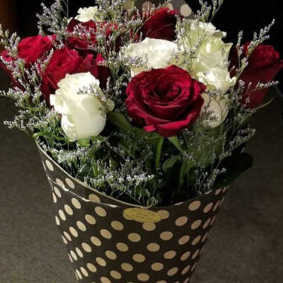 Bouquet of red and white roses in a polka-dot wrap