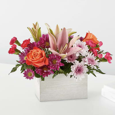 Mixed bouquet in a white rectangular box with pink lilies and orange roses