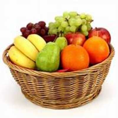 Basket of assorted fruit including bananas, grapes, apples, and oranges