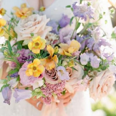 Pastel bouquet with roses and small yellow and lavender flowers