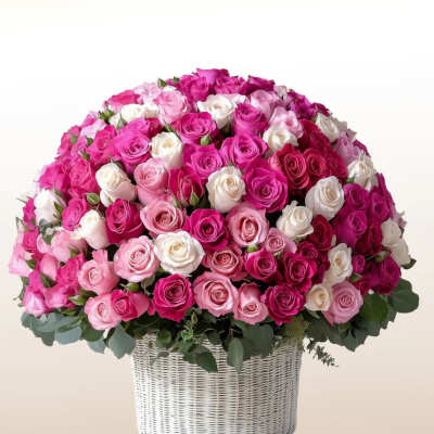 Large basket arrangement of pink, white, and magenta roses