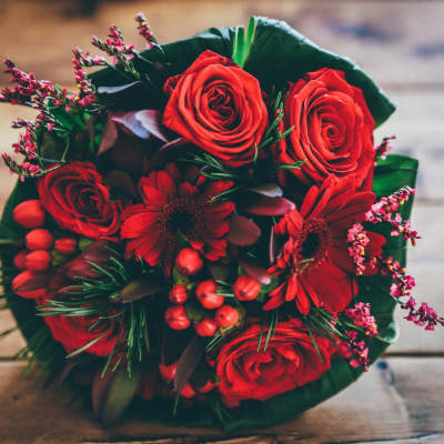 Red rose bouquet with red daisies and berry accents