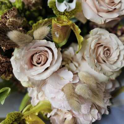 Bouquet of pale pink roses and orchids with fuzzy accents