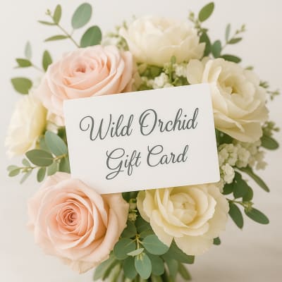 Gift card over a bouquet of pale roses and greenery