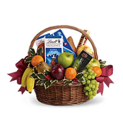 Gift basket with fruit and chocolate bars in a wicker basket