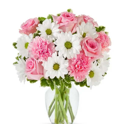Pink roses and carnations with white daisies in a clear glass vase