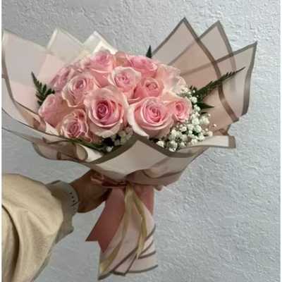 Bouquet of pale pink roses wrapped in blush paper