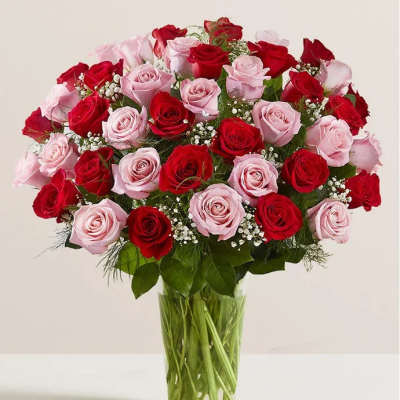 Bouquet of red and pink roses in a clear glass vase