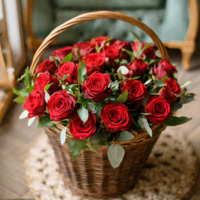 Basket of red roses with greenery