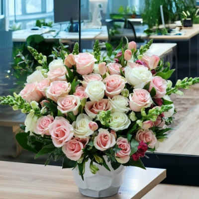Bouquet of pink and white roses in a white vase