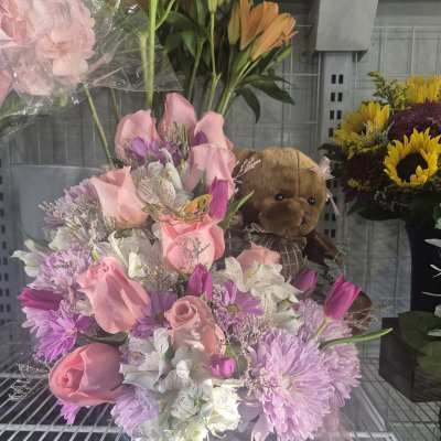 Pink and lavender bouquet with roses, daisies, and a teddy bear